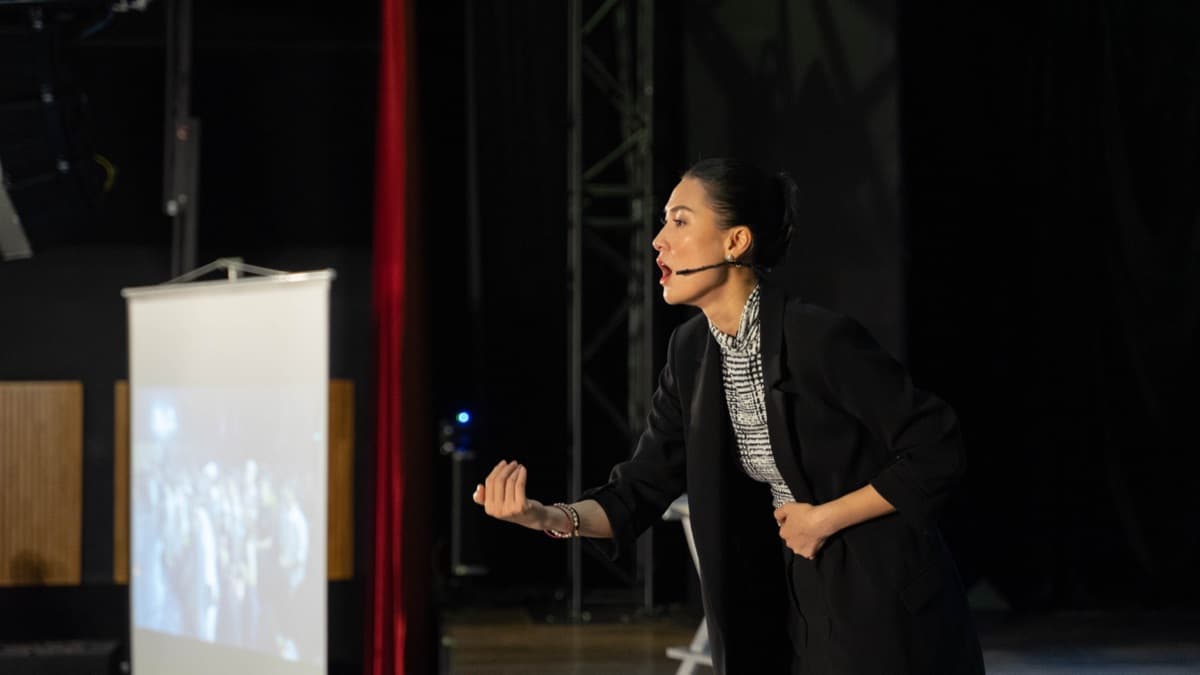 Kathy Uyen mid-keynote on stage