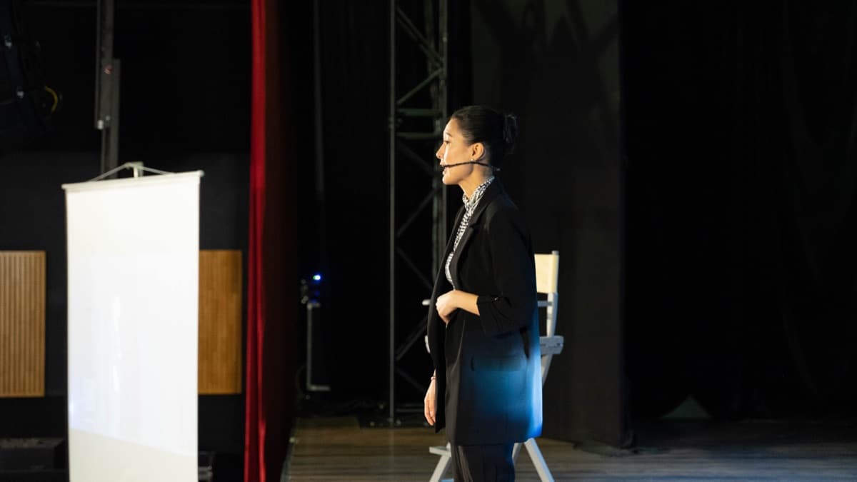 Kathy Uyen presenting to a seated audience