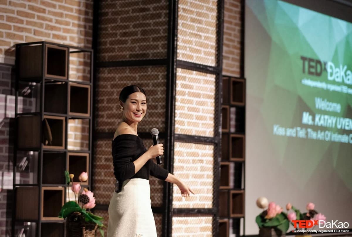 Kathy Uyen speaking with a microphone