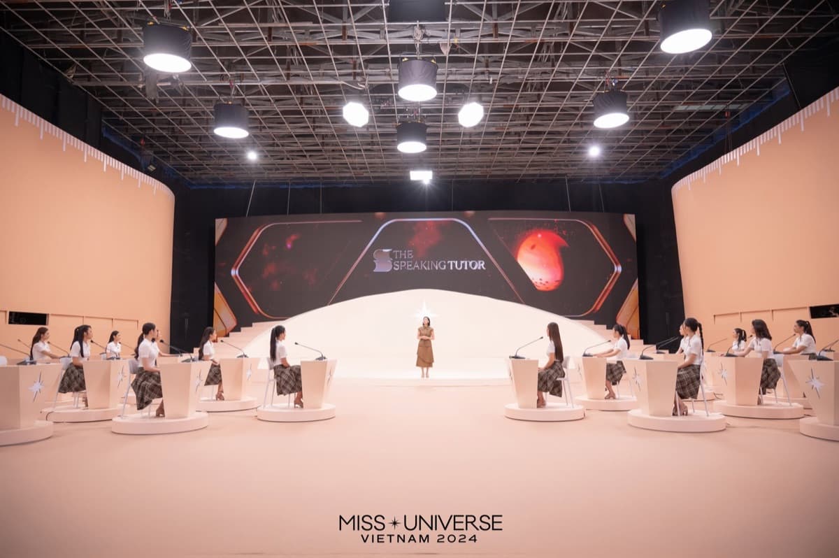 Kathy Uyen on a broadcast stage with delegates