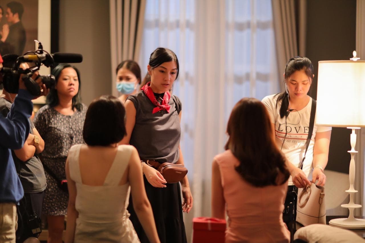 Kathy Uyen working with the cast between takes