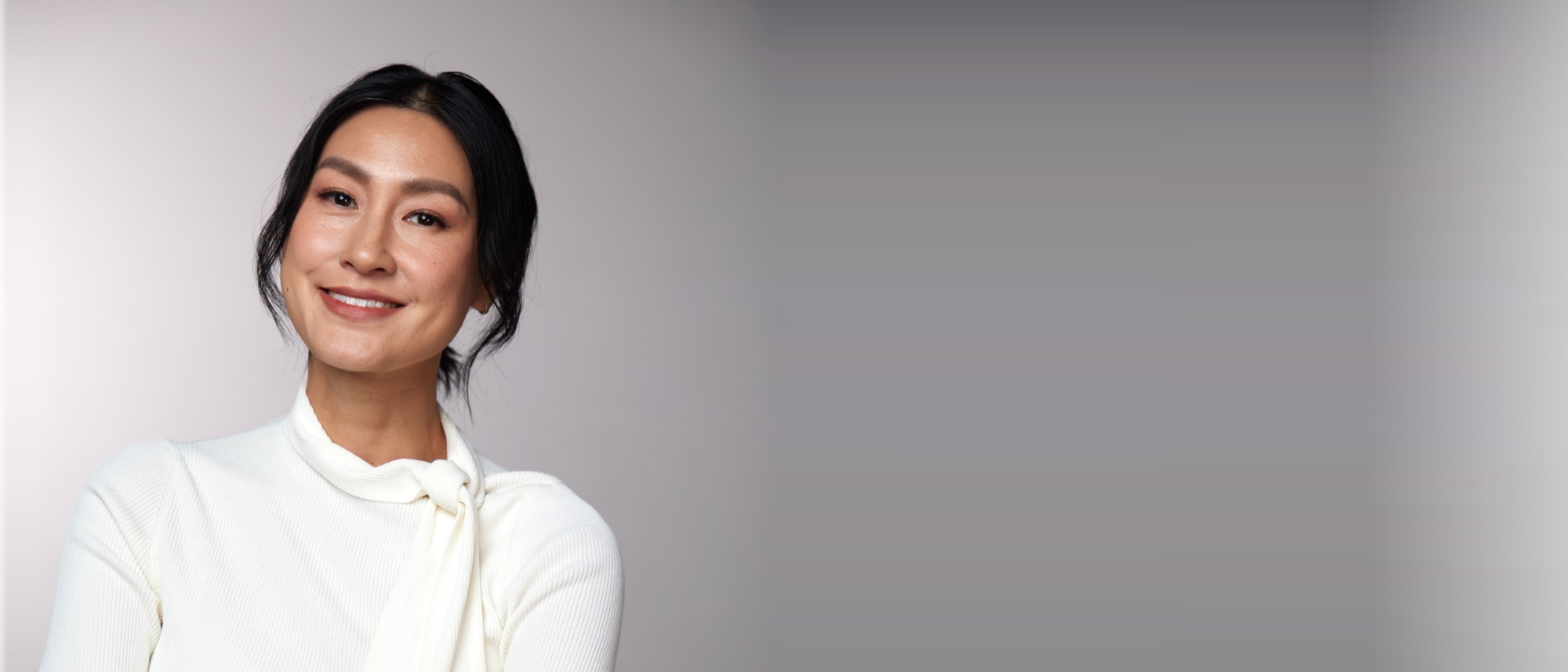 Kathy Uyen, arms folded, calm and self-possessed